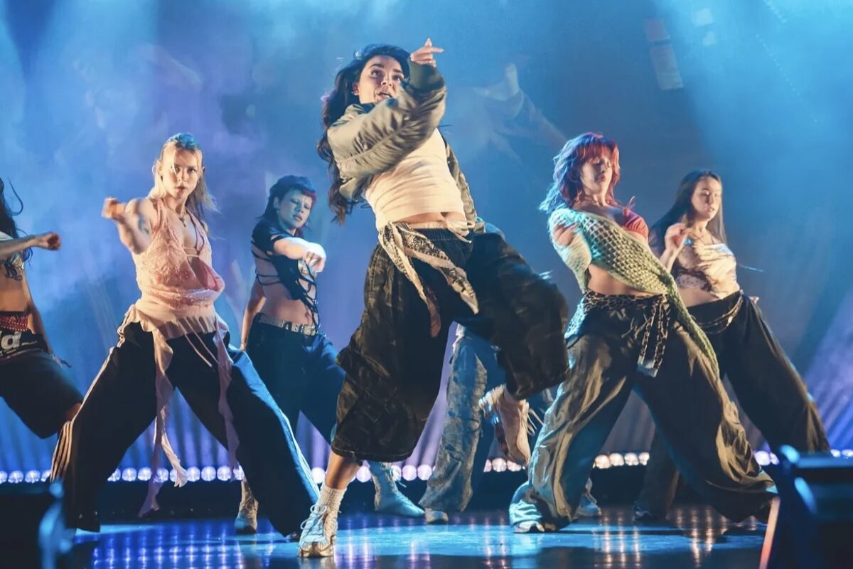 a group of dancers performing on stage